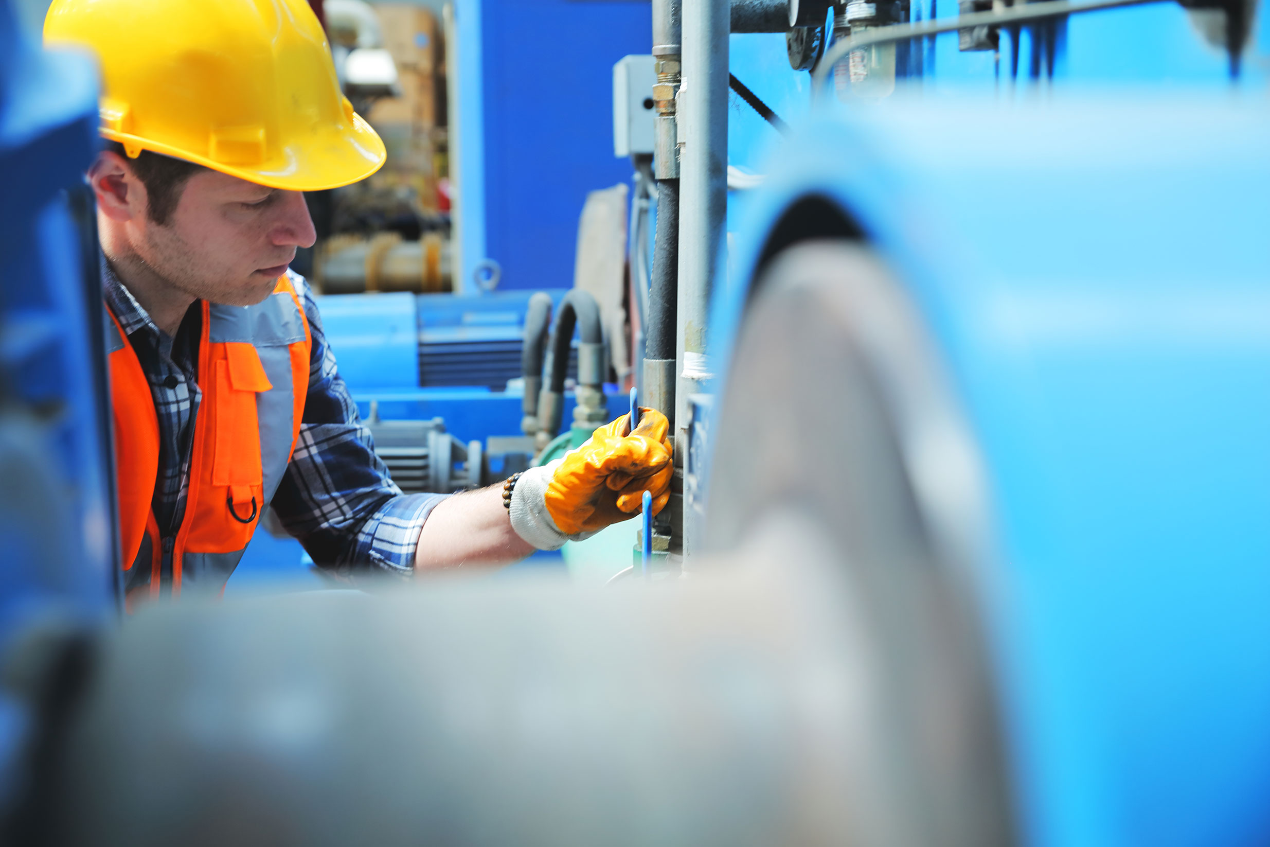 Man Wearing Yellow Hard Hat Fixing a Pipe